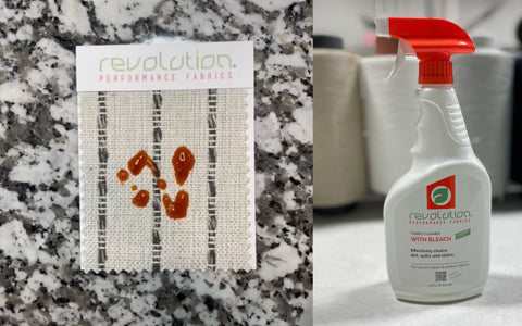 The image features two items: on the left, a sample of Revolution Performance Fabrics with visible ketchup stains on a beige and gray striped fabric swatch, demonstrating its stain resistance; on the right, a spray bottle of Revolution Performance Fabrics' fabric cleaner with bleach, labeled for effective cleaning of dirt, spills, and stains, against a background of yarn spools. The juxtaposition highlights the bleach cleanable nature of the fabric.